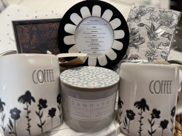 Neutral-toned gift basket with coffee mug, lidded candle, and framed sentiment