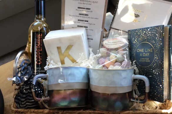 Woven basket with personalized initial mug, snacks, and small decorative items