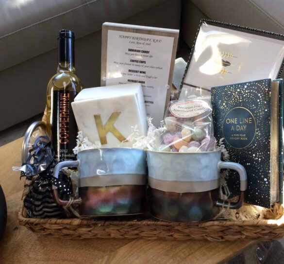 Woven basket with personalized initial mug, snacks, and small decorative items