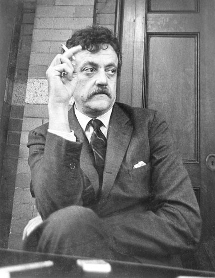 Writer Kurt Vonnegut sits cross-legged, looking reflective, with a cigarette in his hand in this black and white photo taken March 18, 2003