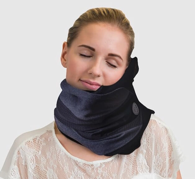 Woman wearing the Trtl Travel Pillow Cool for neck support on a flight