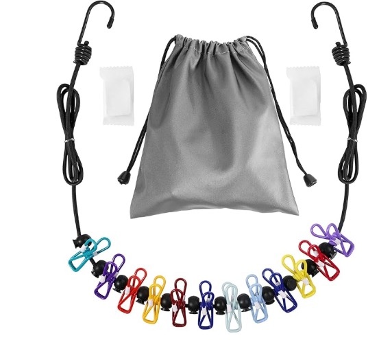 Shirts and pants hanging on a retractable travel clothesline inside a hotel room in Lauterbrunnen, Switzerland.