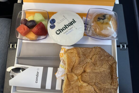 Condor Airlines premium seat breakfast with fresh fruit, croissant, cheese, and yogurt, part of 33 Days in Europe