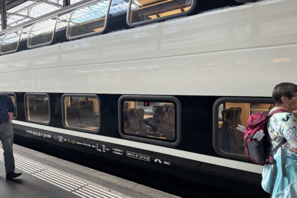 Double-decker Swiss train at the platform in Lucerne, ready for passengers to board.