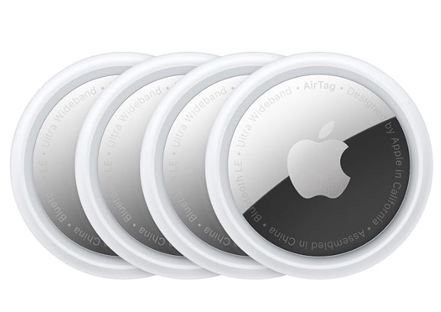 Set of four Apple AirTags used for tracking travel bags and everyday items