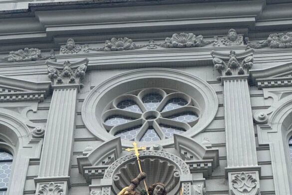 Close-up of ornate church Close-up of the ornate clock and Saint Michael statue on the façade of St. Leodegar Church in Lucerne, Switzerland