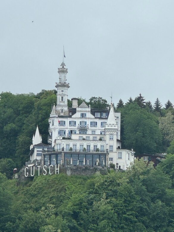 Hilltop view of Château Gütsch above Lucerne, late‑19th‑century castle‑style hotel seen through mist