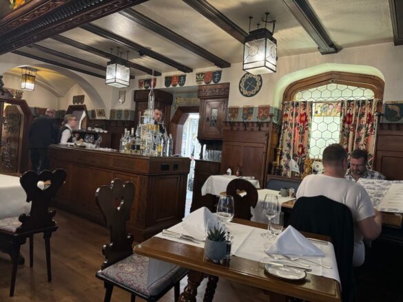 Interior view of the traditional wooden bar and dining area at Restaurant Burgerstube in Lucerne.