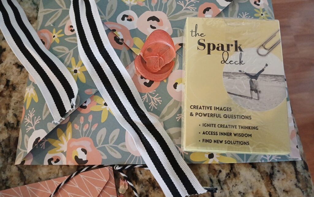 Spark Cards gift with handmade floral envelope, striped ribbon, and custom wax seal by Deborah Bass