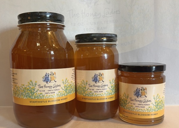 Three jars of The Honey Ladies Star Thistle Blossom Honey in various sizes