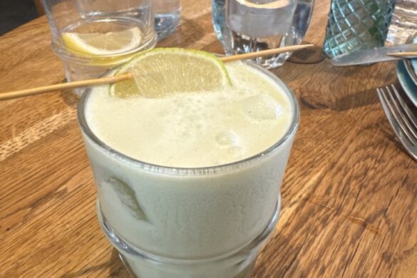 Creamy spicy matcha drink on a wooden table at Wirtshaus Krienbrüggli in Lucerne.