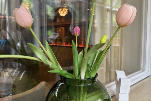 Vase with fresh spring flowers placed on a dining table at Hotel Silberhorn restaurant in Lauterbrunnen, Switzerland