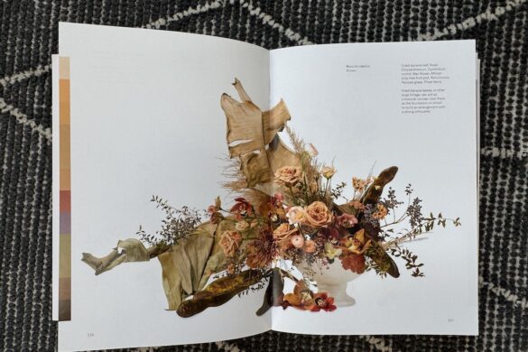 Book spread showing a floral arrangement in bronze, brown, and rust tones, Flower Color Theory, pages 216–217.