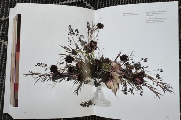 Book spread showing a monochromatic floral arrangement in black with mauve accent, Flower Color Theory, page 366.