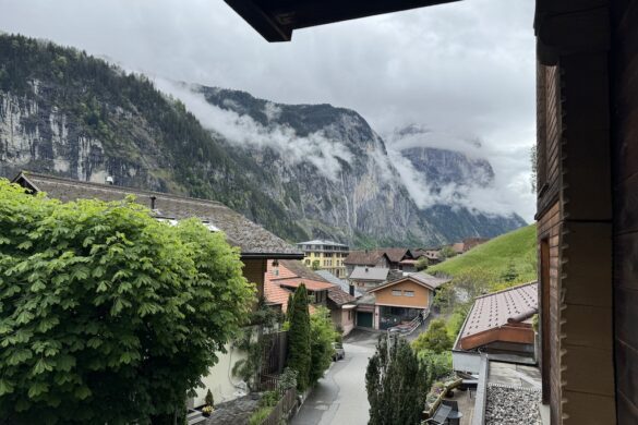 View from a hotel balcony toward rooftops and alpine cliffs in Lauterbrunnen, Switzerland