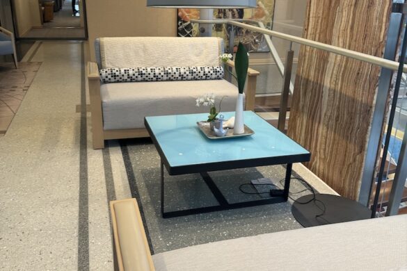 Small seating area off to the side of the ship’s main lounge with modern chairs, tables, and soft lighting