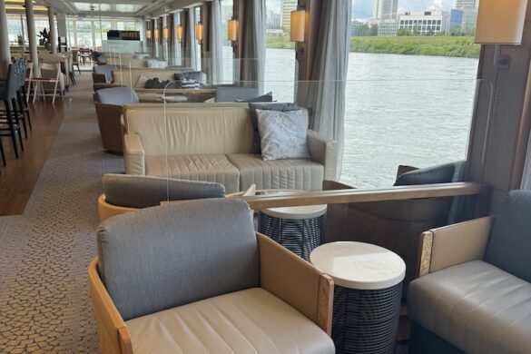 Lounge area aboard the Viking Alruna with curved chairs and river views through large windows