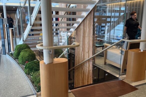 Central atrium of the Viking Alruna showing glass stair rails, polished floors, and contemporary Scandinavian design