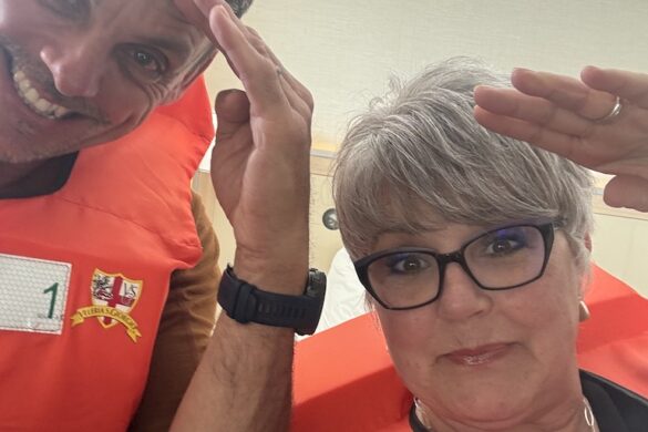 Deborah and Ron posing playfully during the Viking Alruna safety drill, wearing orange vests and smiling