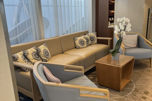 Seating nook aboard the Viking Alruna with chairs and table near large windows and soft natural light