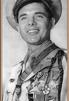 Portrait of Audie Murphy in uniform displaying his numerous medals and decorations from World War II.