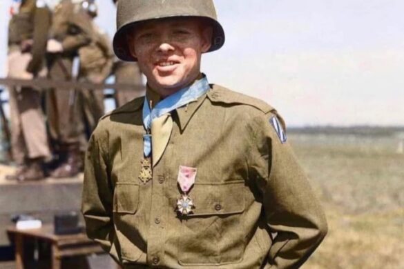 Audie Murphy in military uniform wearing his Medal of Honor, standing outdoors in 1945.