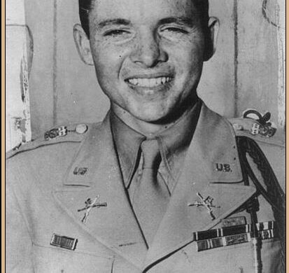 Young Audie Murphy in military uniform, smiling for a portrait after World War II.