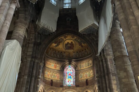Interior view inside Strasbourg Cathedral showing arches and the altar area