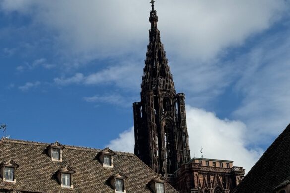 Cathedral spire rising against a blue sky in Strasbourg