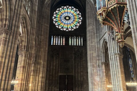 Stained glass window inside Strasbourg Cathedral with colorful panels and leaded sections