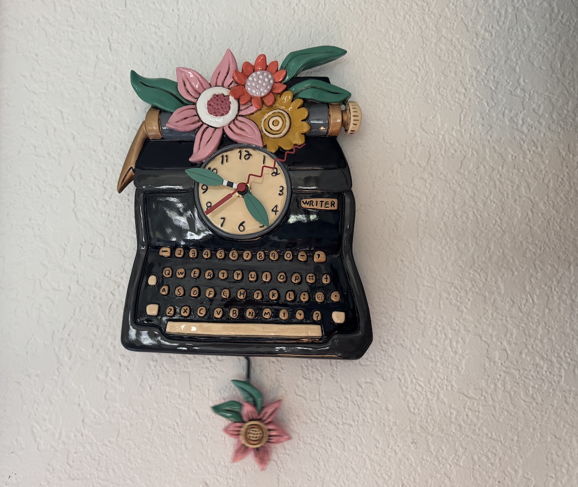 Allen Designs Writer pendulum wall clock with flowers and swinging pendulum