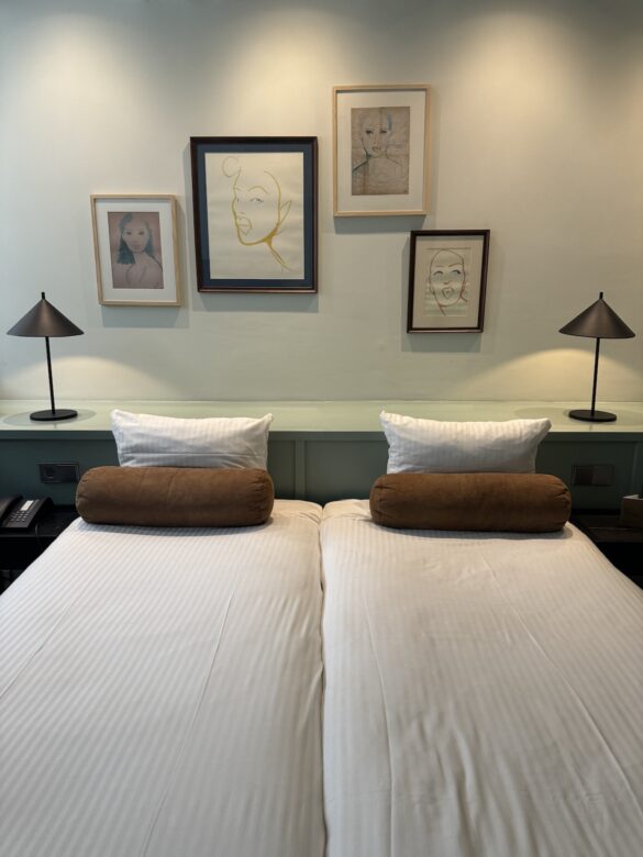 twin beds with white bedding in hotel room at the times hotel amsterdam