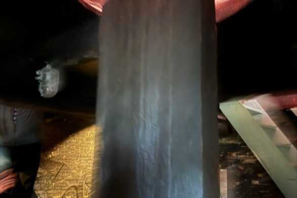 large vertical drive shaft inside historic Kinderdijk windmill machinery system