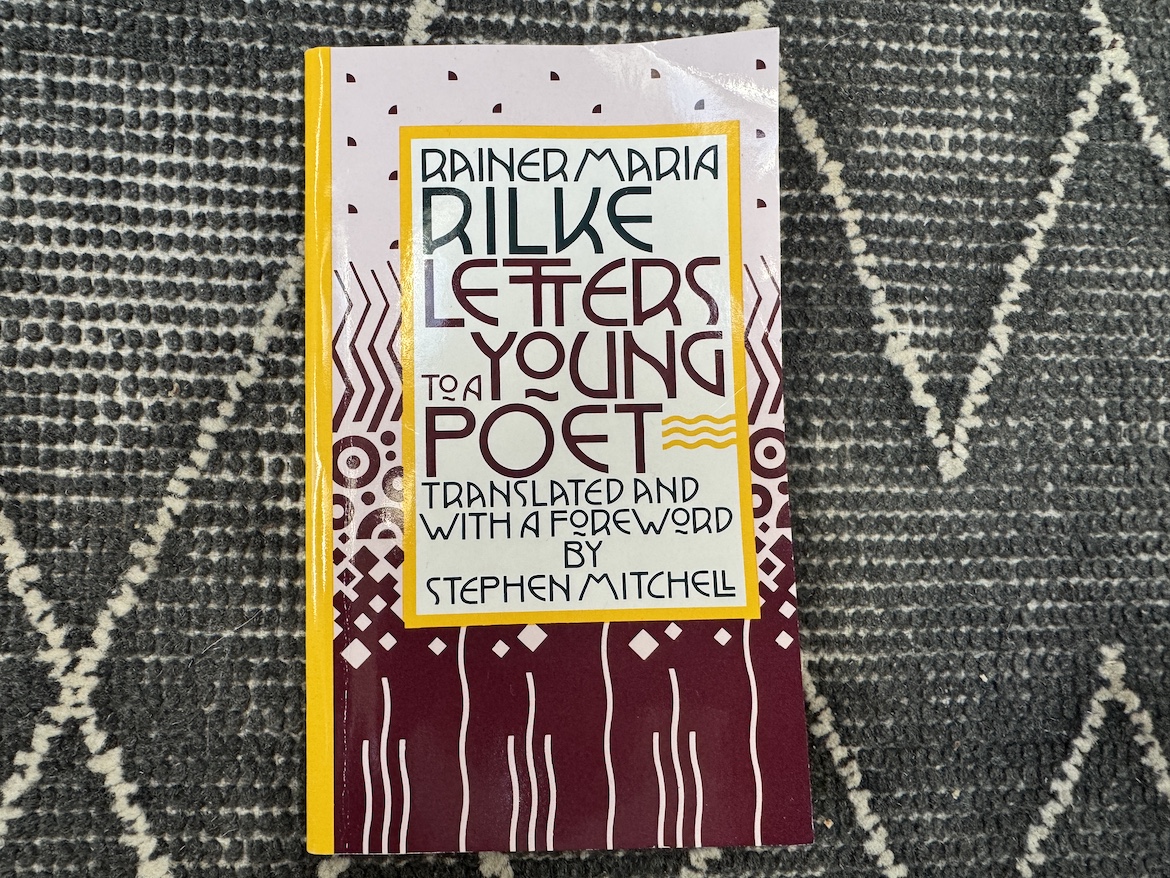 book cover of Letters to a Young Poet by Rainer Maria Rilke on patterned surface