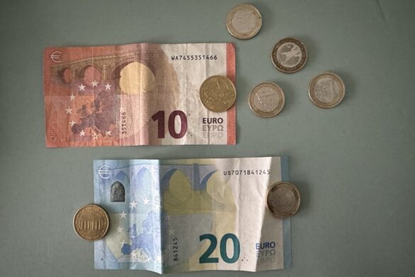 Colorful ten and twenty euro banknotes with euro coins arranged on a tabletop
