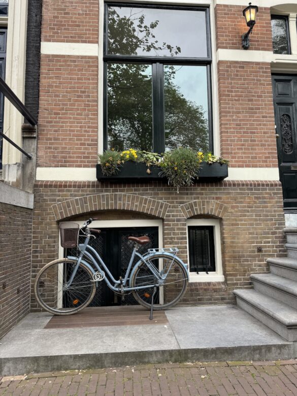 Classic Dutch bicycle parked in front of a brick townhouse in Amsterdam