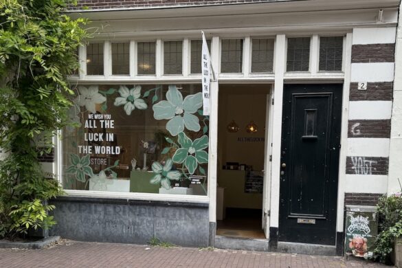 Amsterdam boutique storefront with the words All the Luck in the World displayed in the window