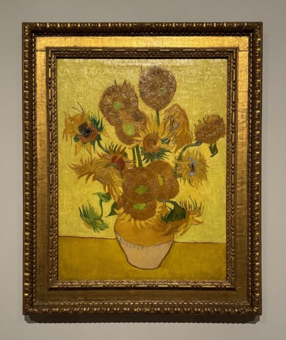 Vincent van Gogh painting Sunflowers in a vase glowing in gold and yellow tones at the Van Gogh Museum