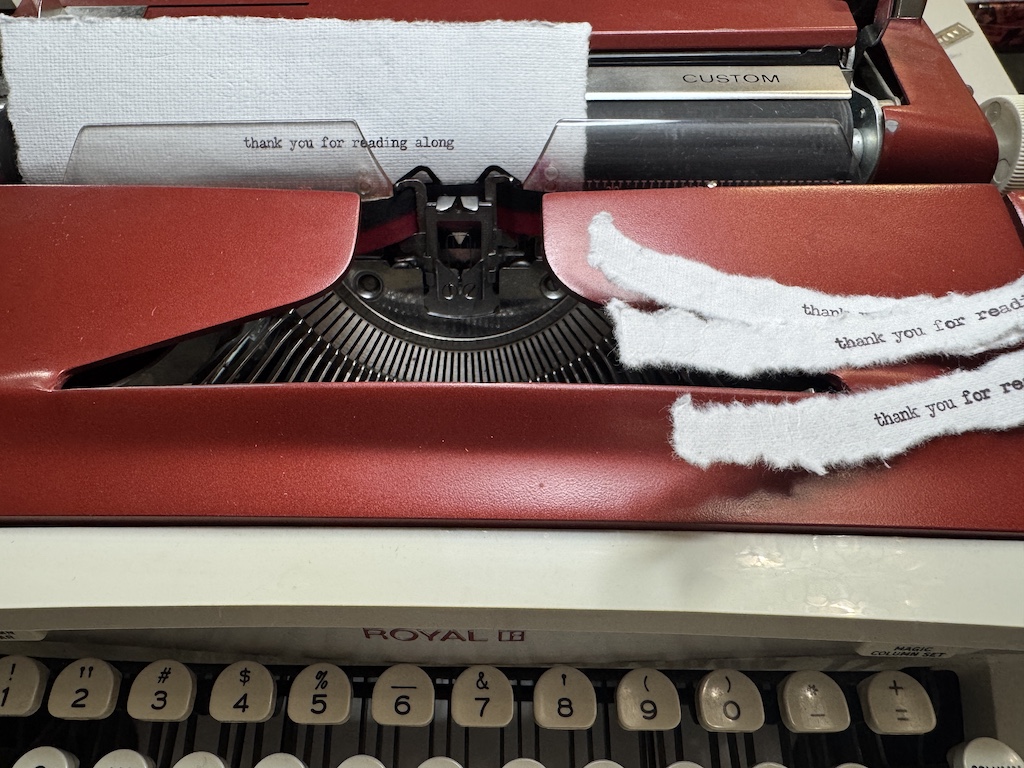 vintage royal red typewriter on crafting desk with paper and tools