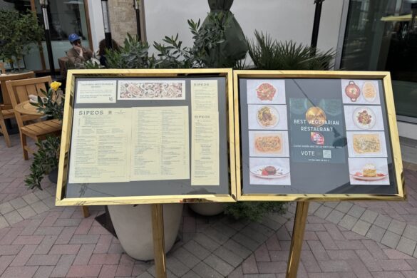 Outdoor menu display at Sipeos restaurant in Walnut Creek showing menu offerings and Best Vegetarian Restaurant finalist signage