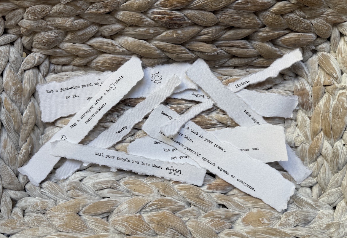 Torn typewritten notes collected in a woven basket for How to Be Happy
